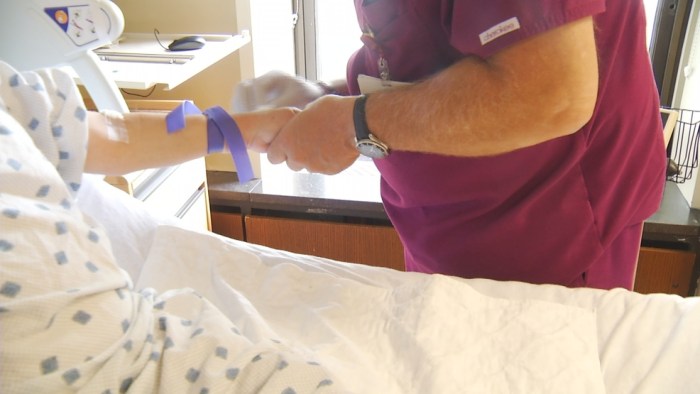 A nurse is discontinuing a peripheral iv catheter